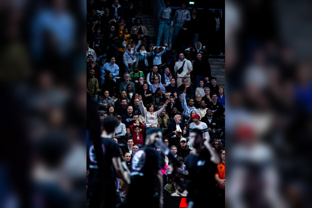 Plan sur un public nombreux, souriant et enthousiaste dans les gradins de l'Adidas Arena pour soutenir le Paris Basketball.