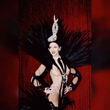 Lido Normandie,  Artiste posant devant rideau rouge en costume final.